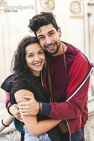 Smiling couple embracing each other on vacation