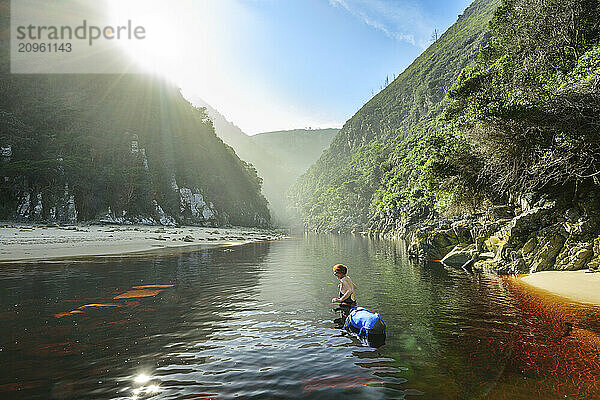 Hiker crossing Lottering River at Otter Trail in Tsitsikamma Section  Garden Route National Park  Eastern Cape  South Africa