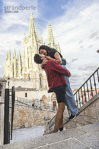 Affectionate couple standing in front of Burgos Cathedral