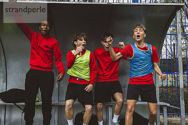 Cheerful soccer players celebrating victory