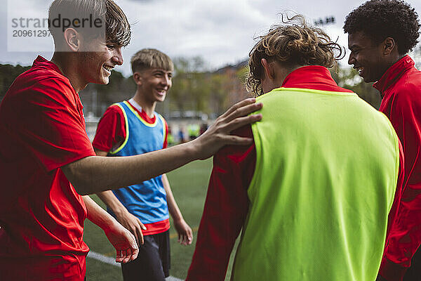 Happy soccer players having training at field