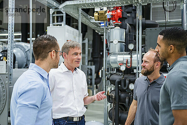 Businessmen and employees having a meeting in factory