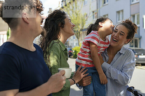 Family and friends spending leisure time at street