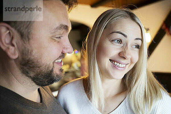 Happy man and woman smiling at home