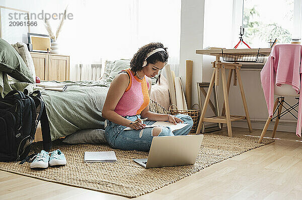 Curly haired girl doing homework at home