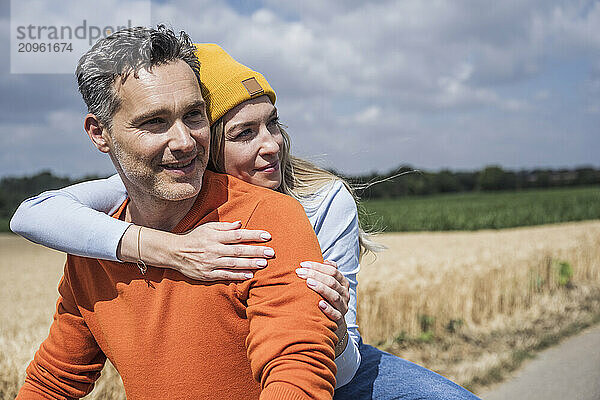 Thoughtful man and woman on sunny day