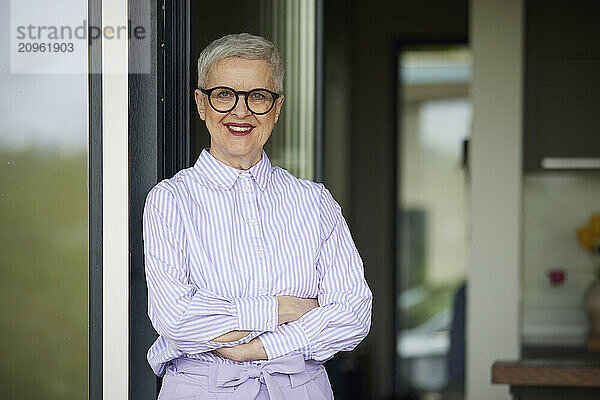 Portrait of confident senior woman at home