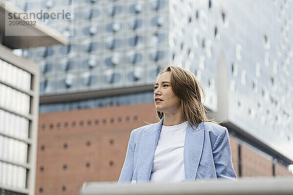 Thoughtful businesswoman in smart casual near Elbphilharmonie