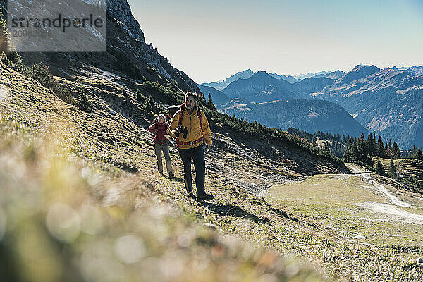 Friends with backpack hiking on mountain