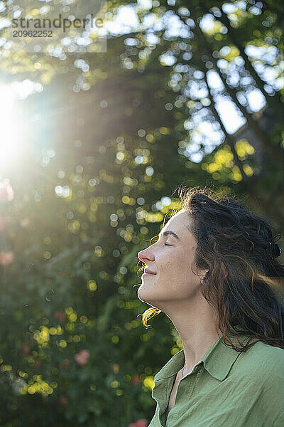 Beautiful woman with eyes closed at sunny day