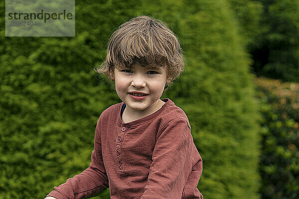 Cute brown hair boy in back yard