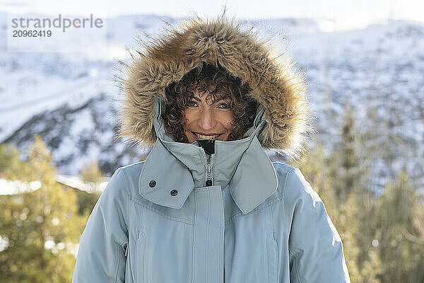 Happy woman in parka coat with fur hood