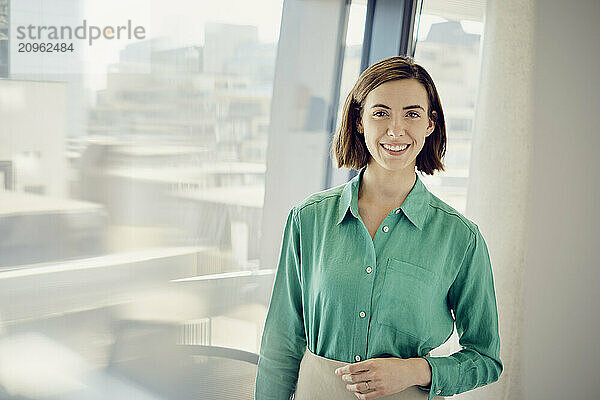 Smiling young businesswoman at office