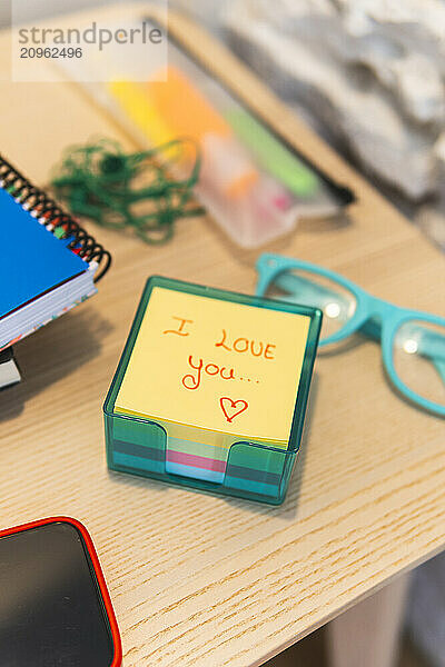 Box of adhesive notes with i love you text in hotel room