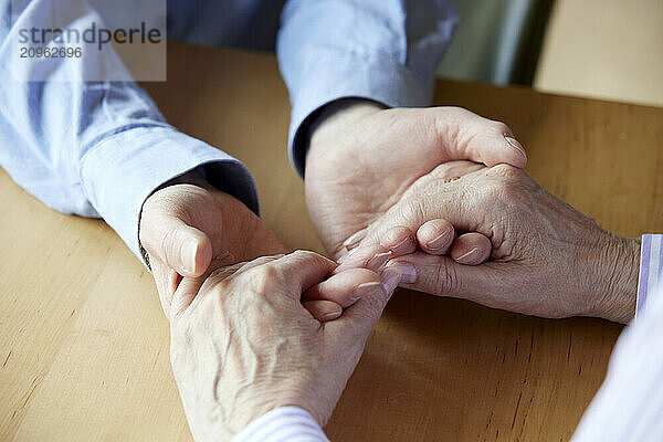 Close-up of senior couple holding hands