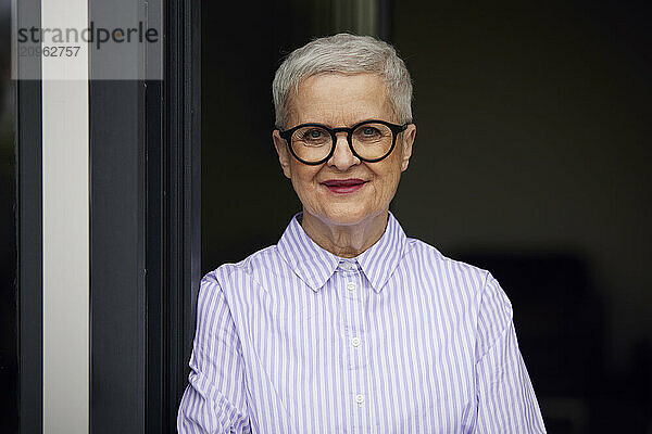 Portrait of confident senior woman at home