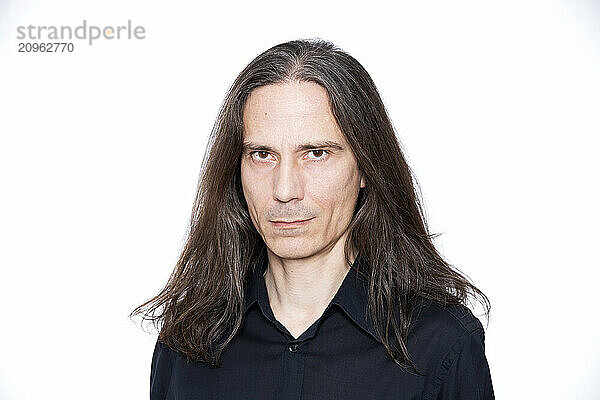 Mature man with long hair against white background