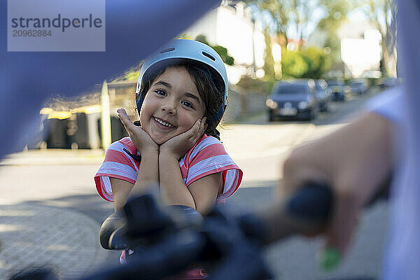 Cute girl wearing helmet posing at street