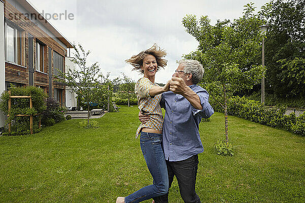 Happy couple dancing in back yard