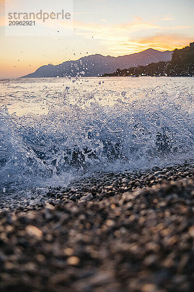 Breaking waves on Brela beach at sunset