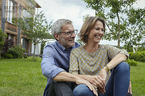 Happy couple spending leisure time in back yard