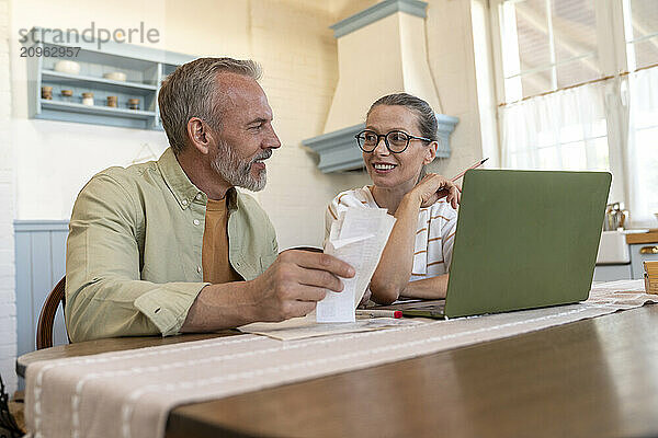 Man and woman preparing financial bills at home