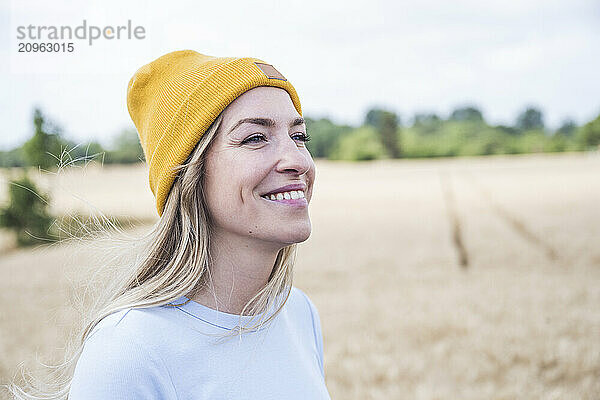 Smiling woman wearing yellow knit hat