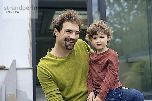 Happy father with son in back yard