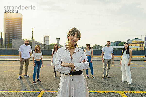 Happy woman standing with friends in background