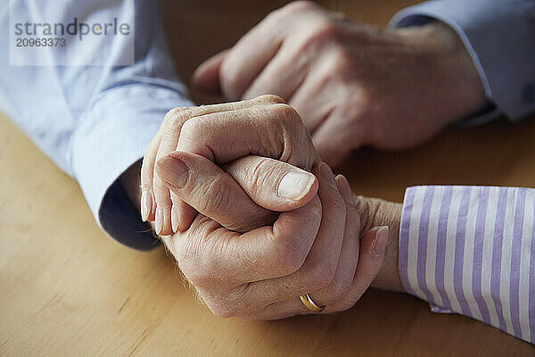 Close-up of senior couple holding hands