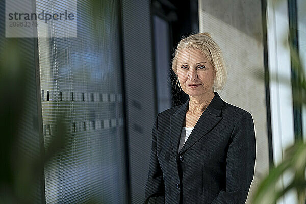 Smiling blond businesswoman in blazer