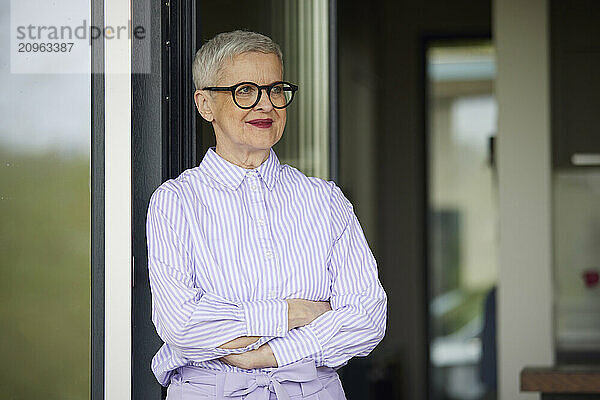 Confident senior woman with short grey hair at home