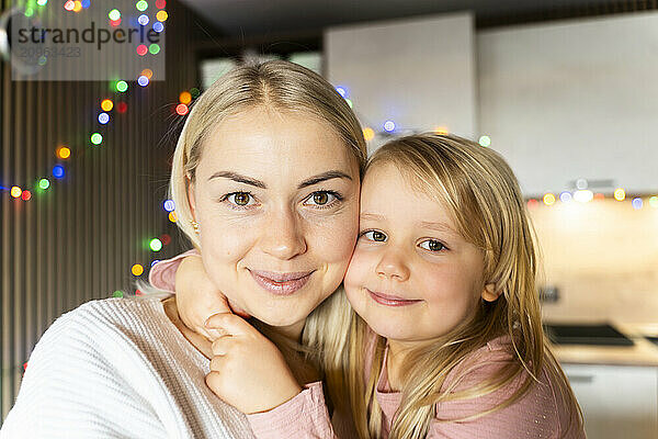 Daughter embracing mother at home