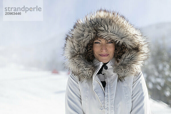 Smiling woman in parka coat with fur hood