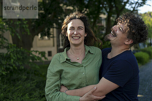 Cheerful man enjoying leisure time with girlfriend at street