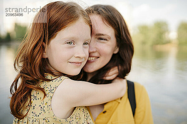 Thoughtful girl with mother in park