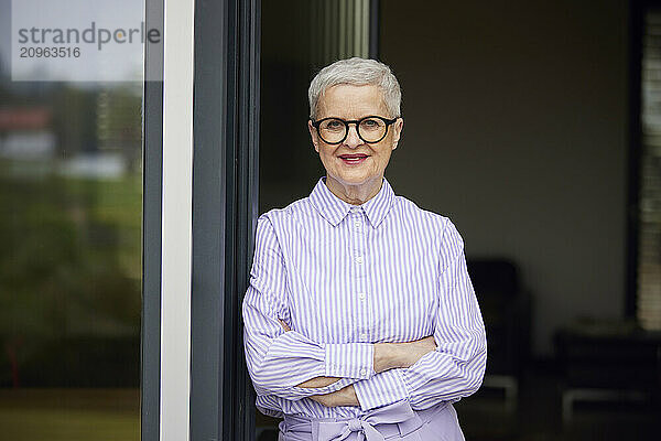 Portrait of confident senior woman at home