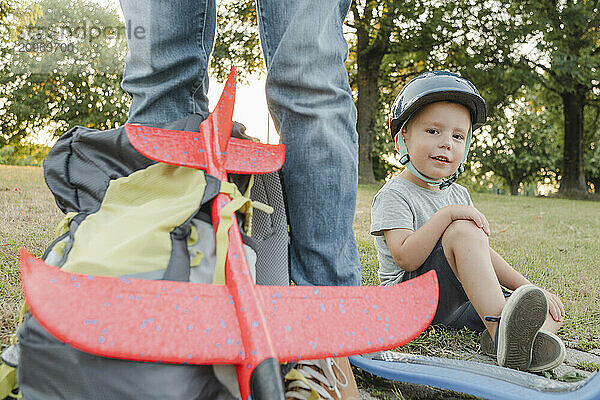 Cute boy wearing helmet and sitting in park