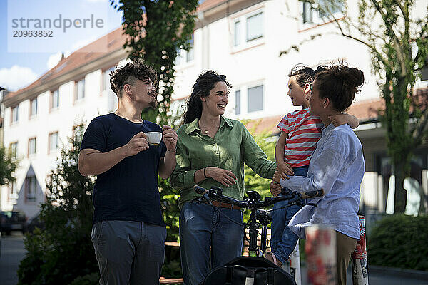 Family and friends discussing at street