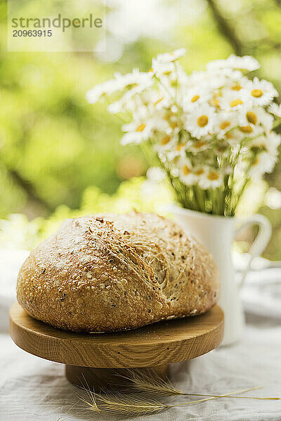 Daisies in vase and freshly baked homemade sourdough bread