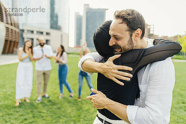 Loving couple hugging each other in park