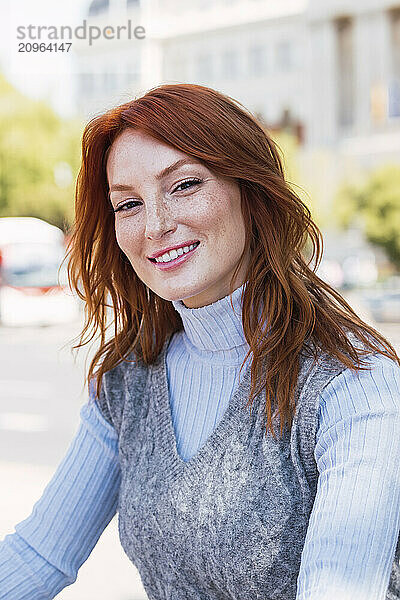 Happy beautiful redhead woman on street