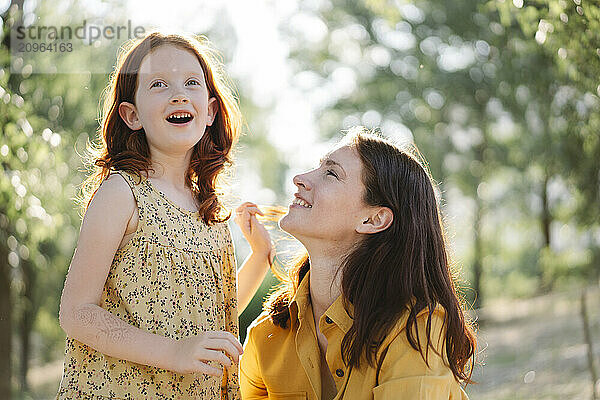 Happy mother and daughter spending leisure time in park