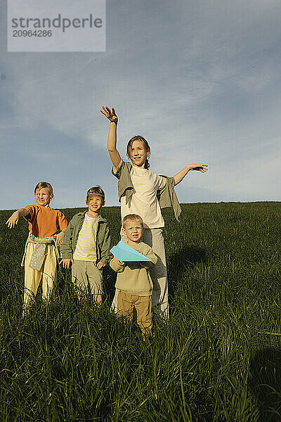 Playful siblings enjoying in meadow