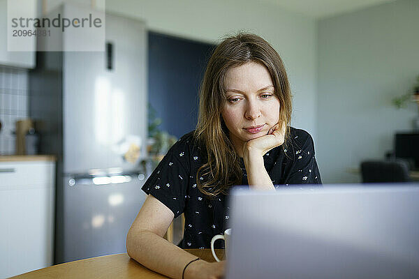 Freelancer working on laptop at table