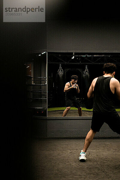 Man warms up before training in the gym.