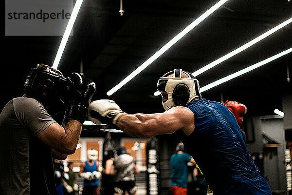 Boxers fighting in boxing training in the gym.