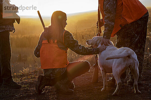 View of three people and dog going hunting  Minnesota  USA