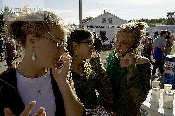 Girls talk on their cell phones  Fryeburg Fair  Maine.