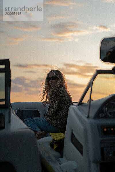 Young woman at sunset on a yacht.